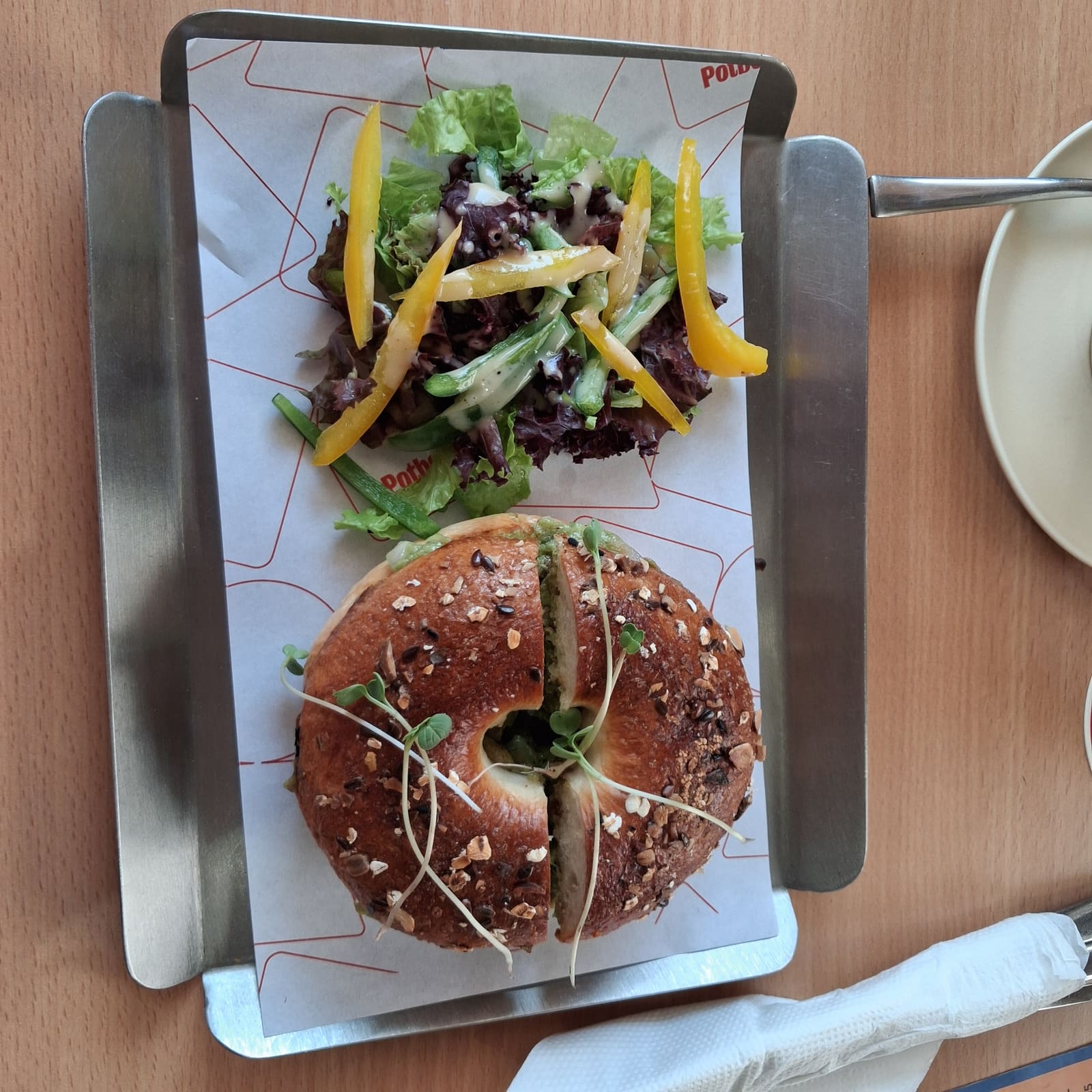 A multigrain bagel sandwich served with a side salad at Potboiler Coffee House in Kolkata.